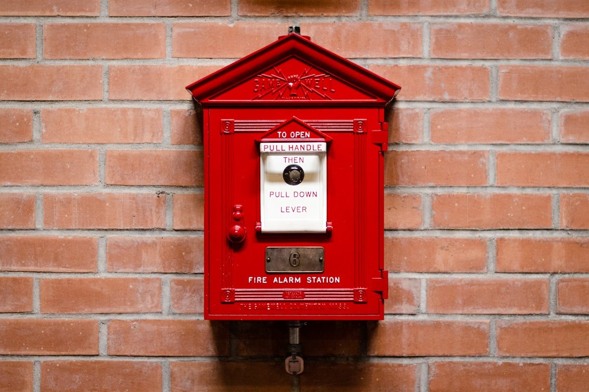 Classic red fire alarm pull station mounted on a wall